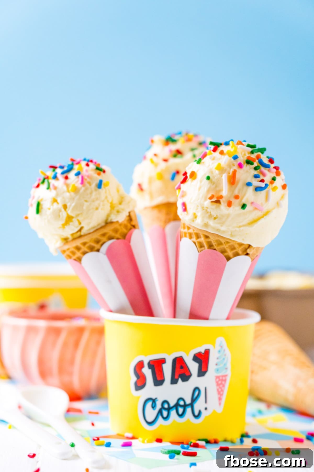 Ice Cream cones resting in a yellow bowl.