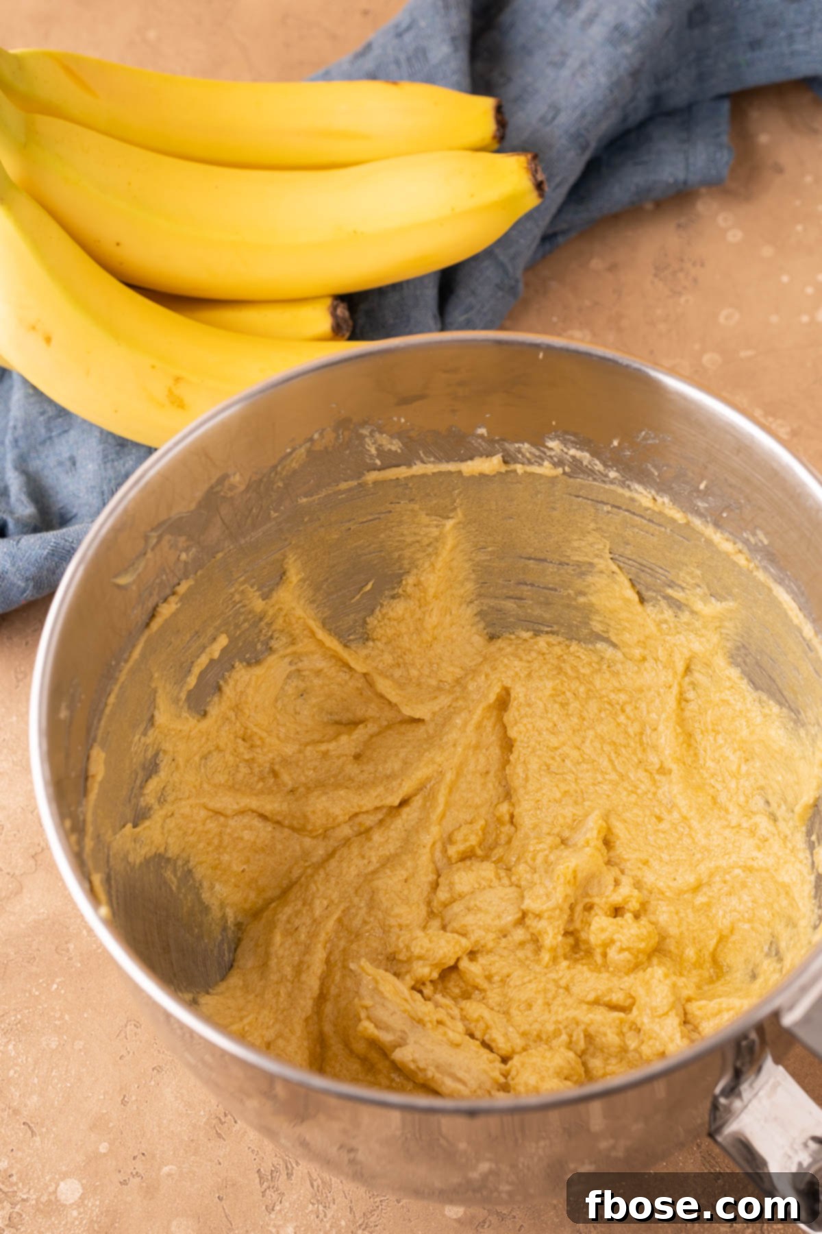 Decadent Chunky Monkey Pudding Cookies 6 Butter, eggs, sugar, mixed to make cookie dough in a stand mixer bowl.