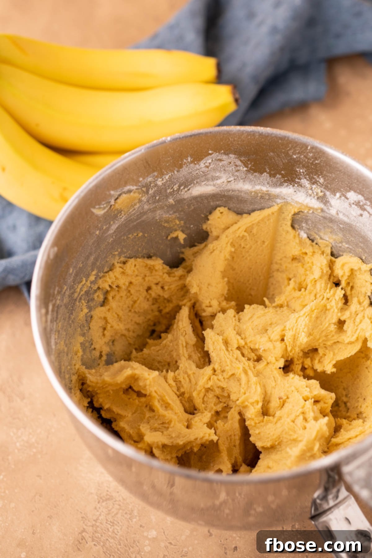 Decadent Chunky Monkey Pudding Cookies 8 Base cookie dough mixture in a stand mixer bowl.