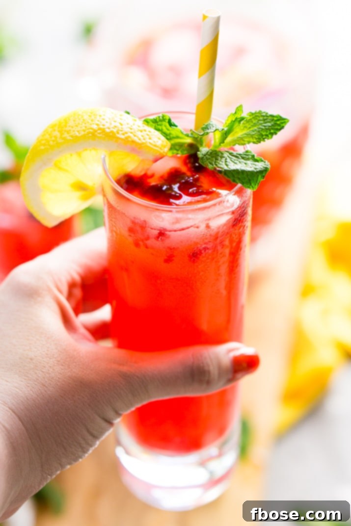Refreshing Raspberry Lemonade Sparkler 6 Multiple glasses of Sparkling Raspberry Lemonade ready to be served, with a pitcher in the background.