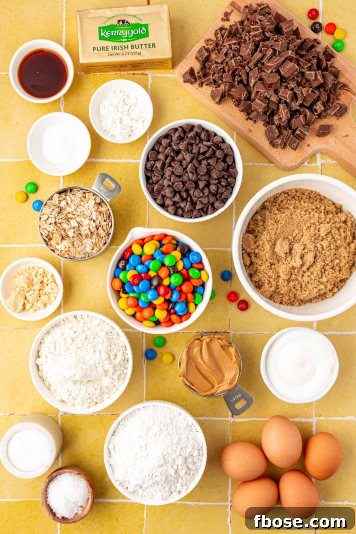 Ingredients to make Monster Cookies on a yellow table.