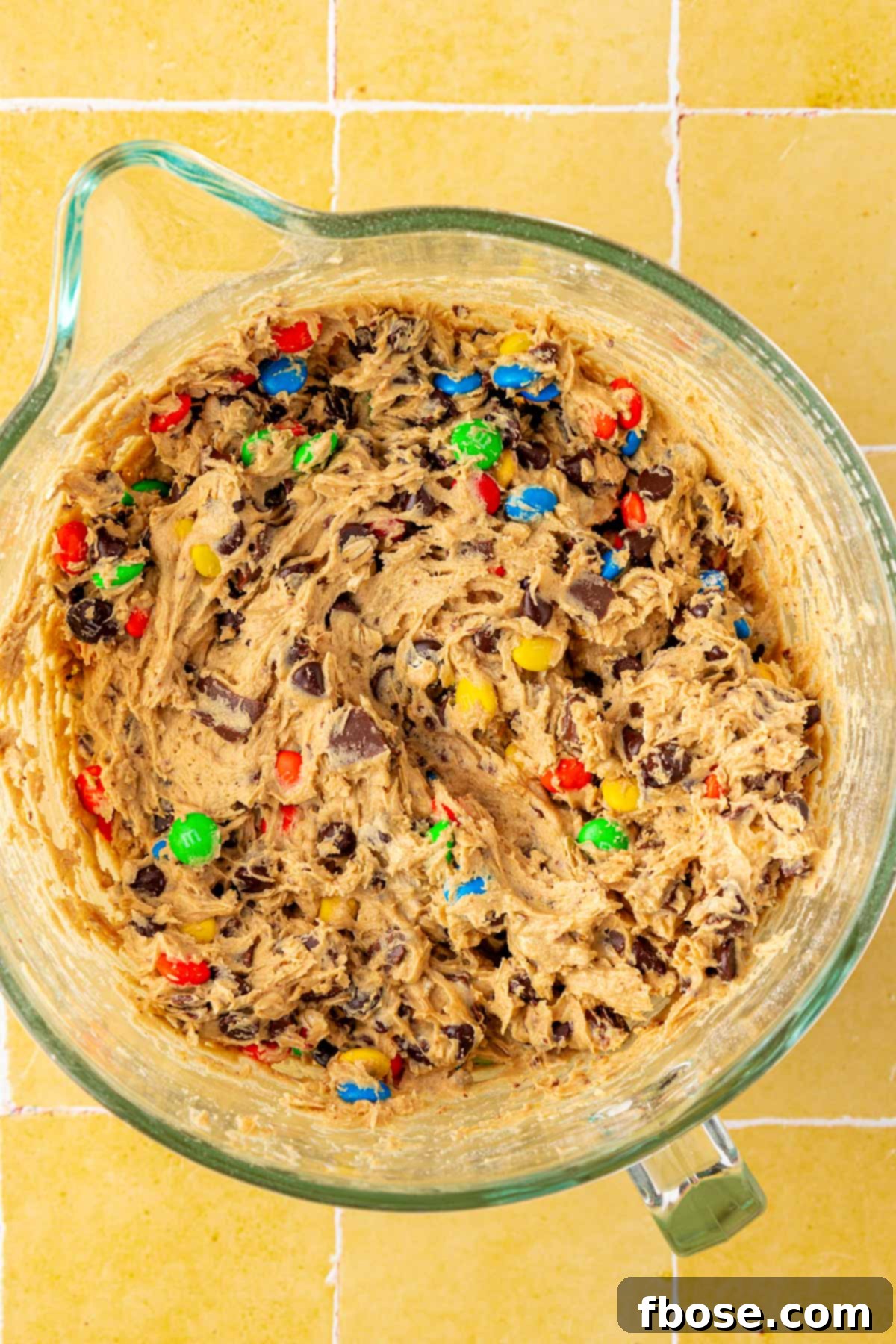 A mixing bowl full of monster cookie dough.