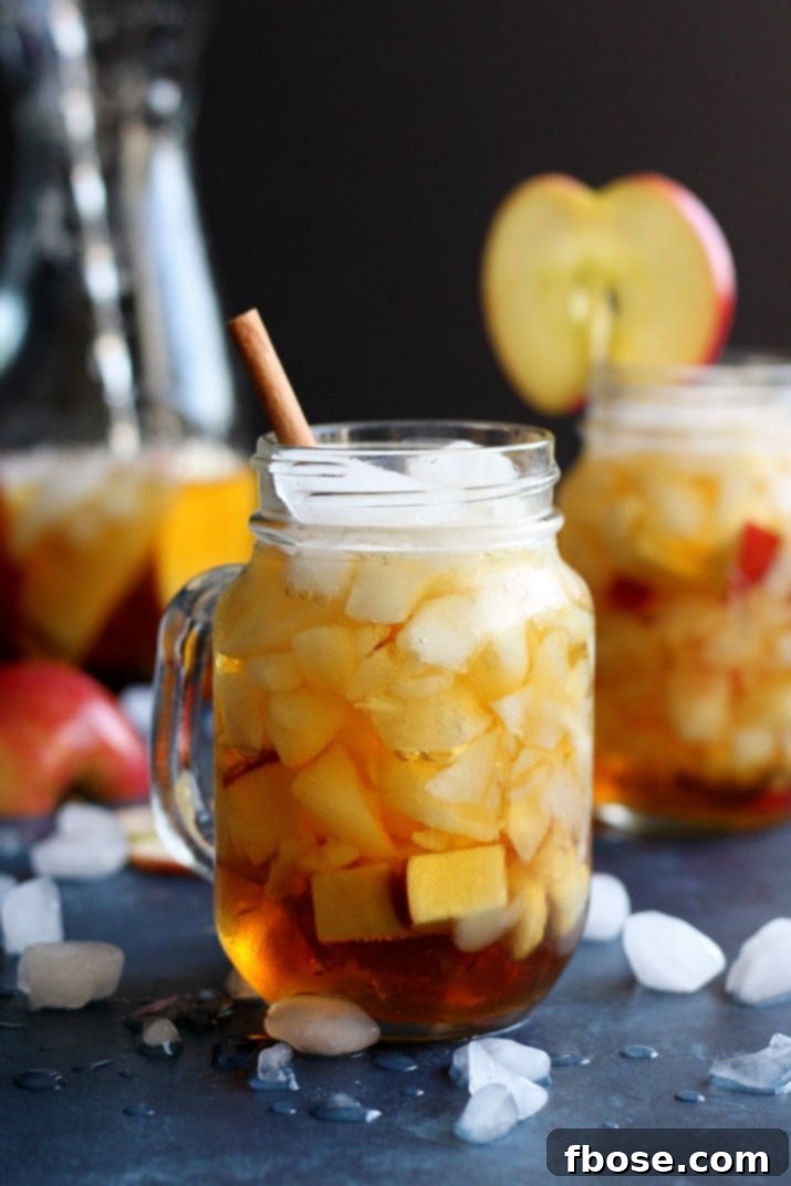 Autumn-inspired Apple Pimm's Cup cocktail with fresh apple slices and cinnamon