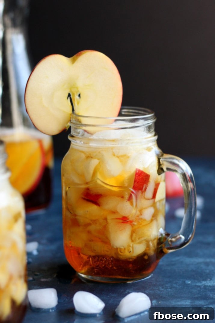 Apple Pimm's Cup cocktail with ice and apple garnish, ready to serve