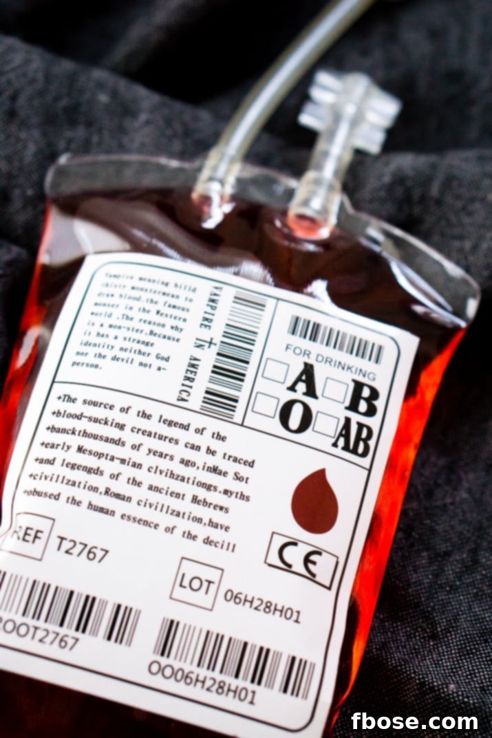 A selection of Blood Bag Cocktails served, showcasing their realistic and spooky presentation for Halloween parties. They are easy to make with just vodka and a red liqueur.