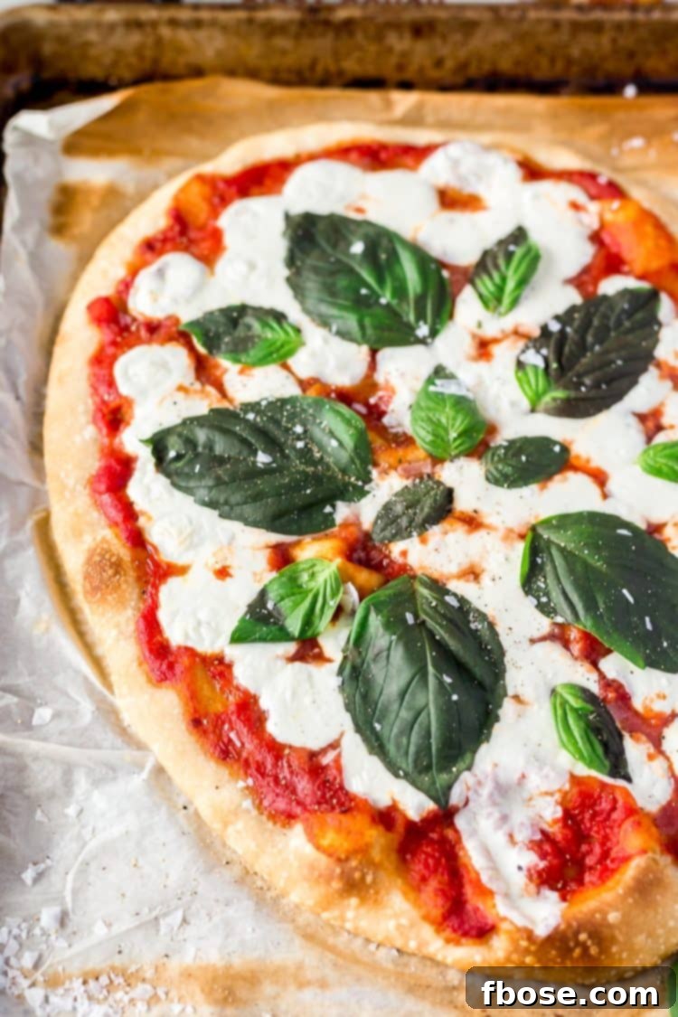 Authentic Margherita Masterpiece 2 A Classic Margherita Pizza made with delicious dough, olive oil, crushed tomatoes, garlic, mozzarella, and basil always hits the spot when you need a quick and easy dinner recipe!