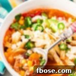This Slow Cooker Chicken Tortilla Soup is loaded with delicious ingredients like chicken, peppers, tomatoes, corn, and beans and the bold flavor of garlic and cayenne! A comforting and hot meal for chilly nights!