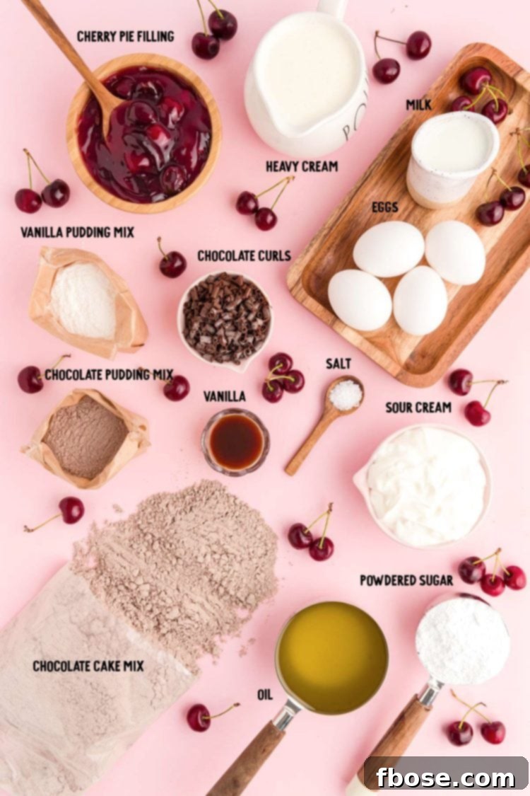 Overhead photo of various ingredients, including a box of cake mix, pudding mix, eggs, sour cream, and milk, all laid out on a pink surface in preparation for baking Black Forest Cupcakes.