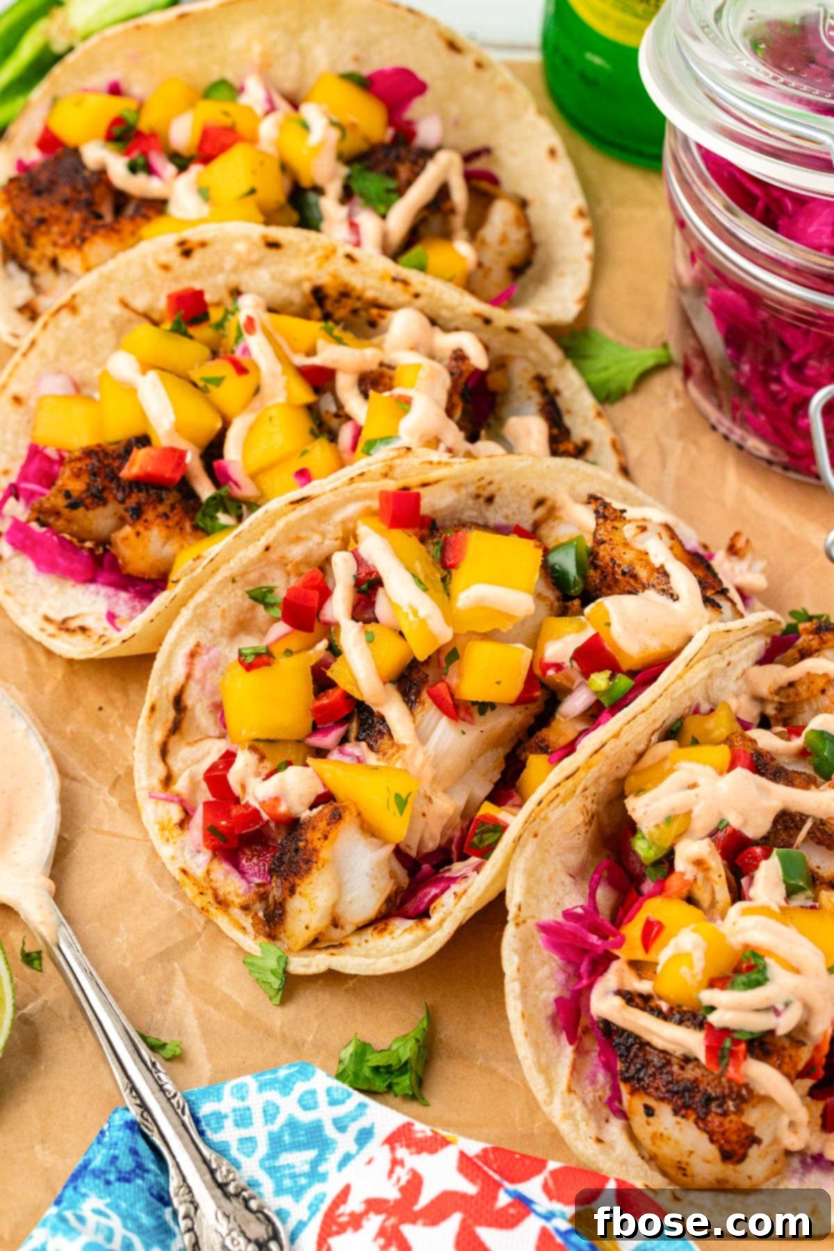 Close up of four blackened fish tacos, showcasing the vibrant ingredients.