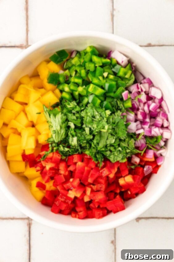 Ingredients in a bowl to make mango salsa.