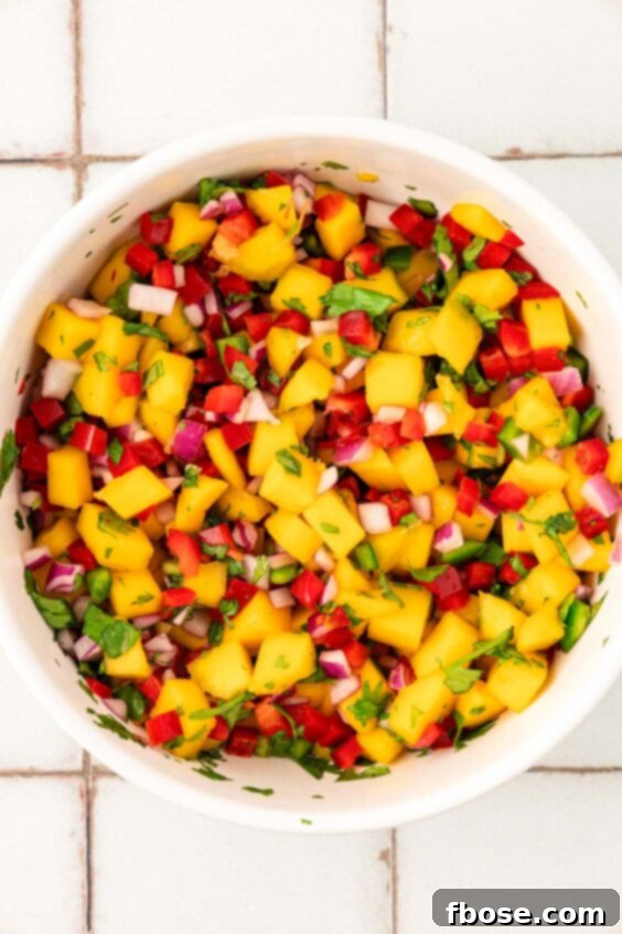 Mango salsa in a white bowl.