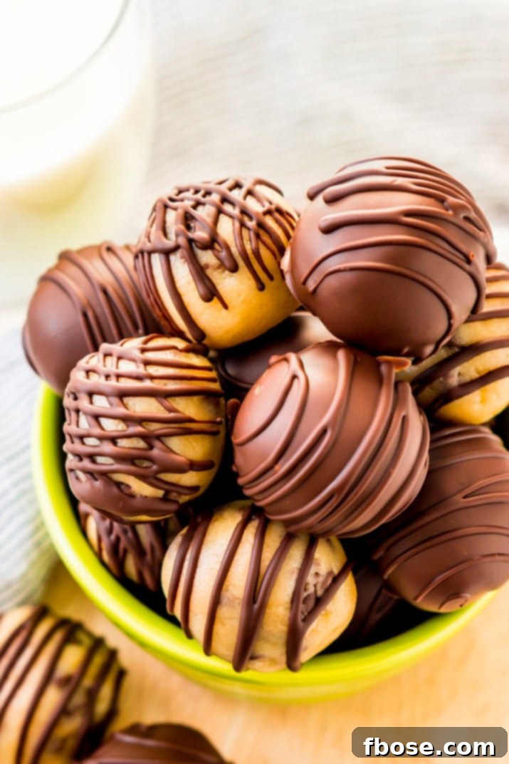 These Cookie Dough Truffles are easy to make, safe to eat, and totally addictive! These chocolate covered treats perfect for parties, game days, or to satisfy cravings any time of the day or night.