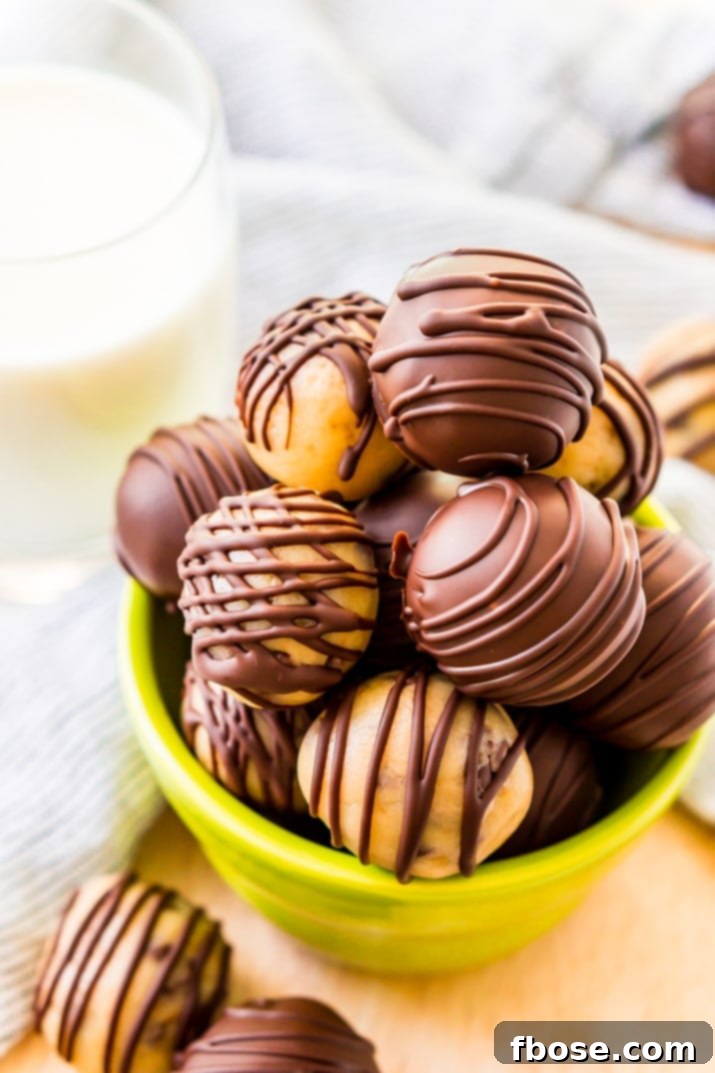 A small green bowl filled with cookie dough truffles.