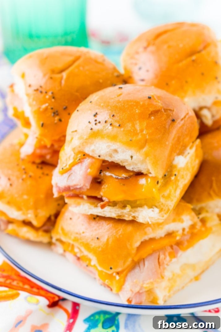 Ingredients for making Ham and Cheese Sliders on Hawaiian Rolls, including honey ham, maple smoked cheddar cheese, and rolls.