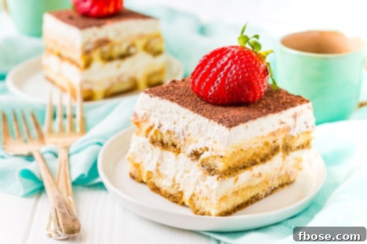 Homemade Tiramisu on White Plate with Strawberry On Top