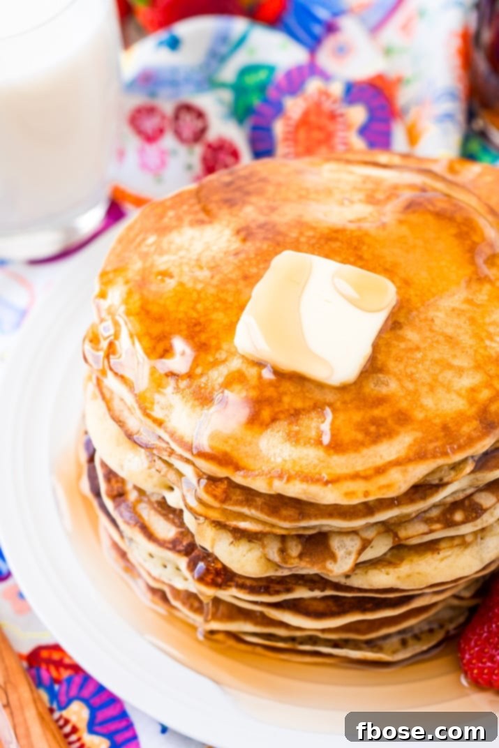 Homemade Buttermilk Pancakes with a pat of butter melting on top