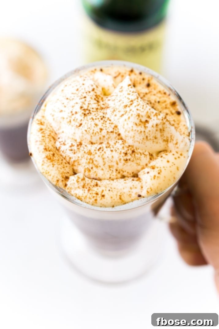 Irish Coffee made with coffee, whiskey, sugar, and whipped cream.