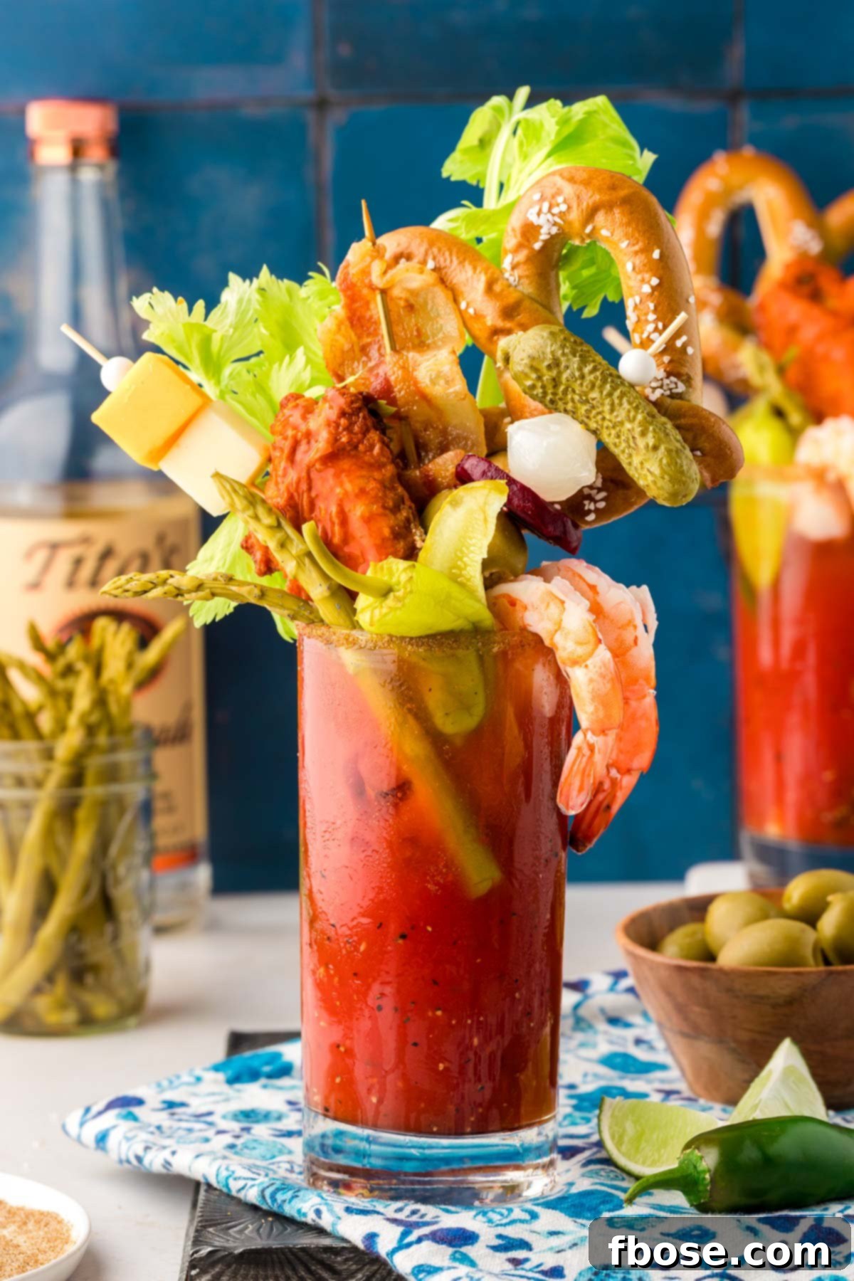The Ultimate Bloody Mary Recipe 2 A glass filled with a Bloody Mary topped with extravagant garnishes for brunch, showcasing its vibrant red color and rich texture.