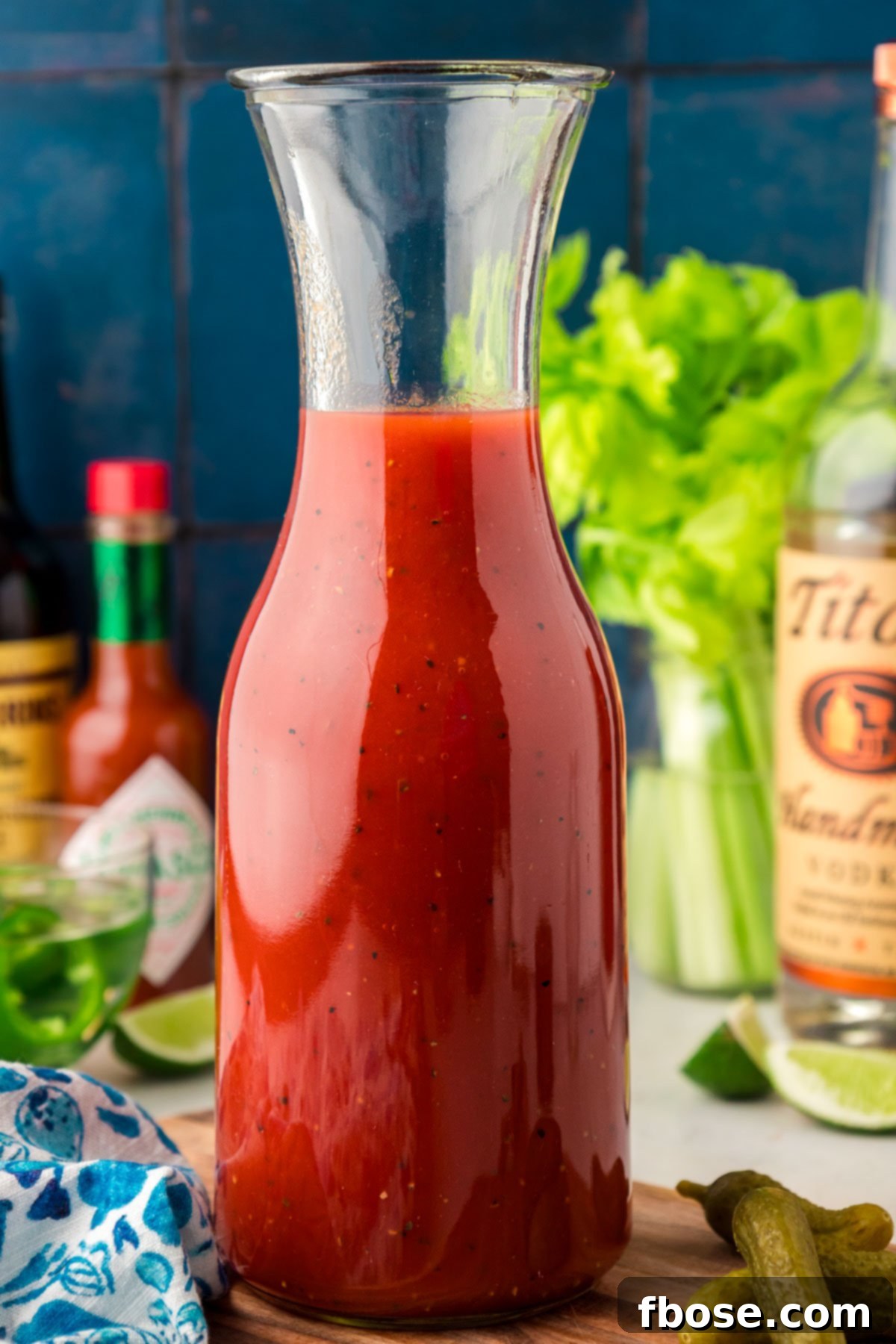 The Ultimate Bloody Mary Recipe 5 A carafe of bloody mary mixture, freshly prepared and ready to be poured, highlighting its vibrant color.