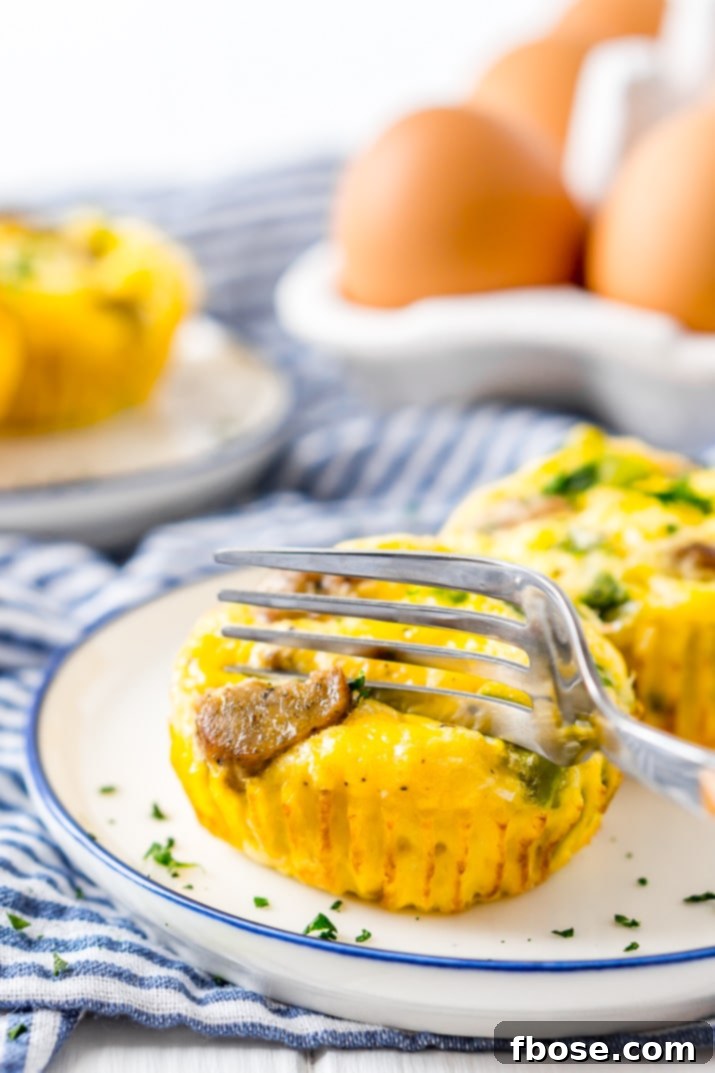 Close-up of golden brown Crustless Mini Quiches, perfect for meal prepping and freezing. A savory blend of eggs, sausage, peppers, and cheese for any meal.
