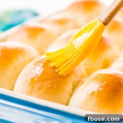 Fluffy, golden-brown homemade yeast rolls ready to be served from a baking pan.