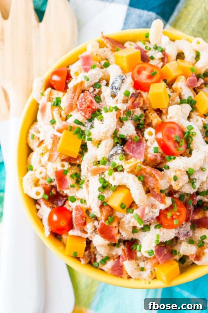 Close-up of Chicken Bacon Ranch Pasta Salad, highlighting the texture of the cavatappi pasta, shredded chicken, and crisp bacon bits, all coated in a savory ranch sauce.