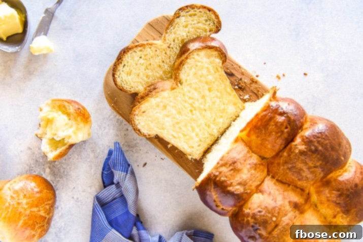 An overhead shot showcasing perfectly sliced brioche bread arranged on a cutting board, highlighting its uniform golden crumb and inviting texture.