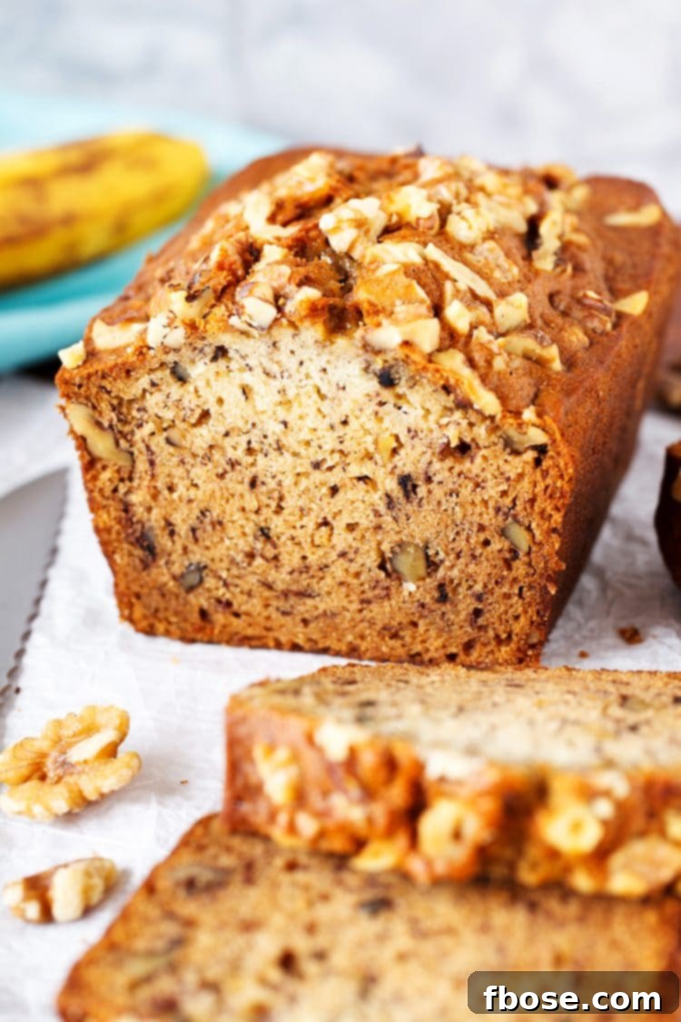 A perfectly baked loaf of Starbucks Copycat Banana Bread, rich with banana flavor and crunchy walnuts, ready to be sliced and enjoyed.