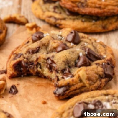 The Definitive Chocolate Chip Cookie 9 Close up of a toll house cookie with a bite missing.