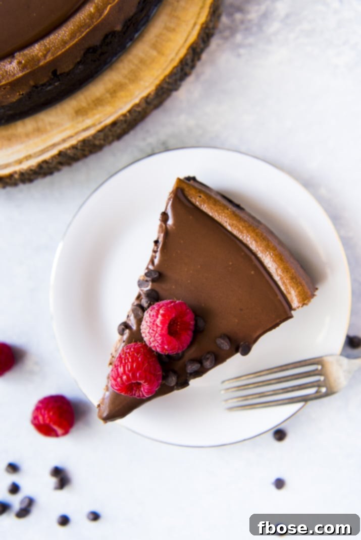 A perfectly sliced triple chocolate cheesecake, ready to be served