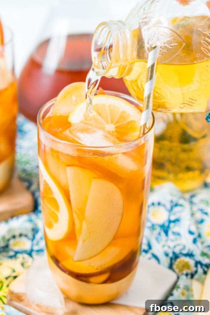 This Homemade Apple Iced Tea is made with freshly brewed black tea, sweet apple juice, fresh apple slices, and a squeeze of lemon for a refreshing summer drink that's easy to make. This flavored iced tea is naturally sweetened by the fruit juice and great for a party! How To Make Apple Iced Tea