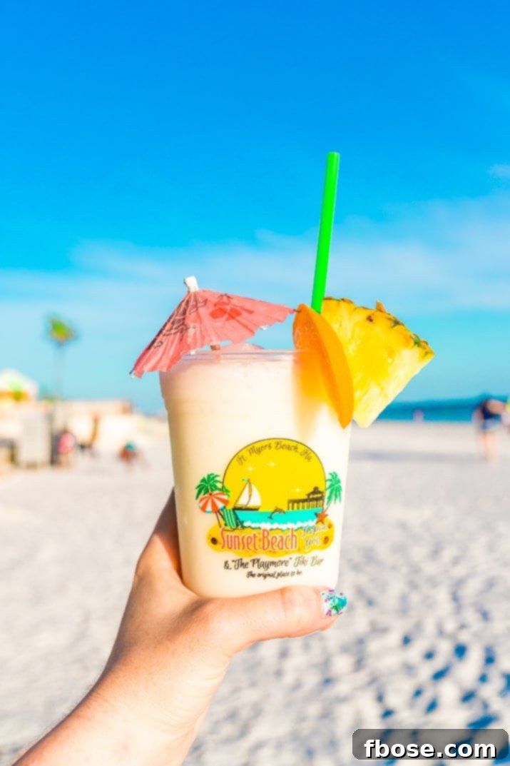 A close-up of a refreshing Pina Colada in a stylish glass, highlighting its smooth, creamy texture and inviting tropical garnishes, ready to be enjoyed on a sunny day.