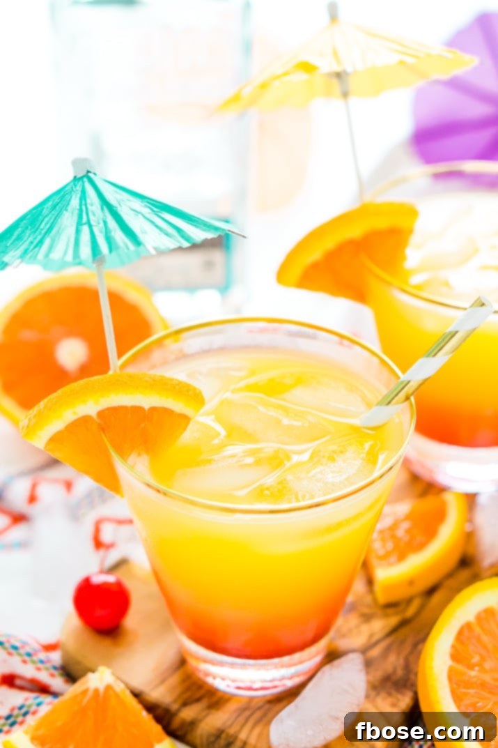 Dawn's Agave Nectar 4 A vibrant Tequila Sunrise cocktail garnished with an orange slice and maraschino cherry, set against a summery backdrop, perfect for social media.