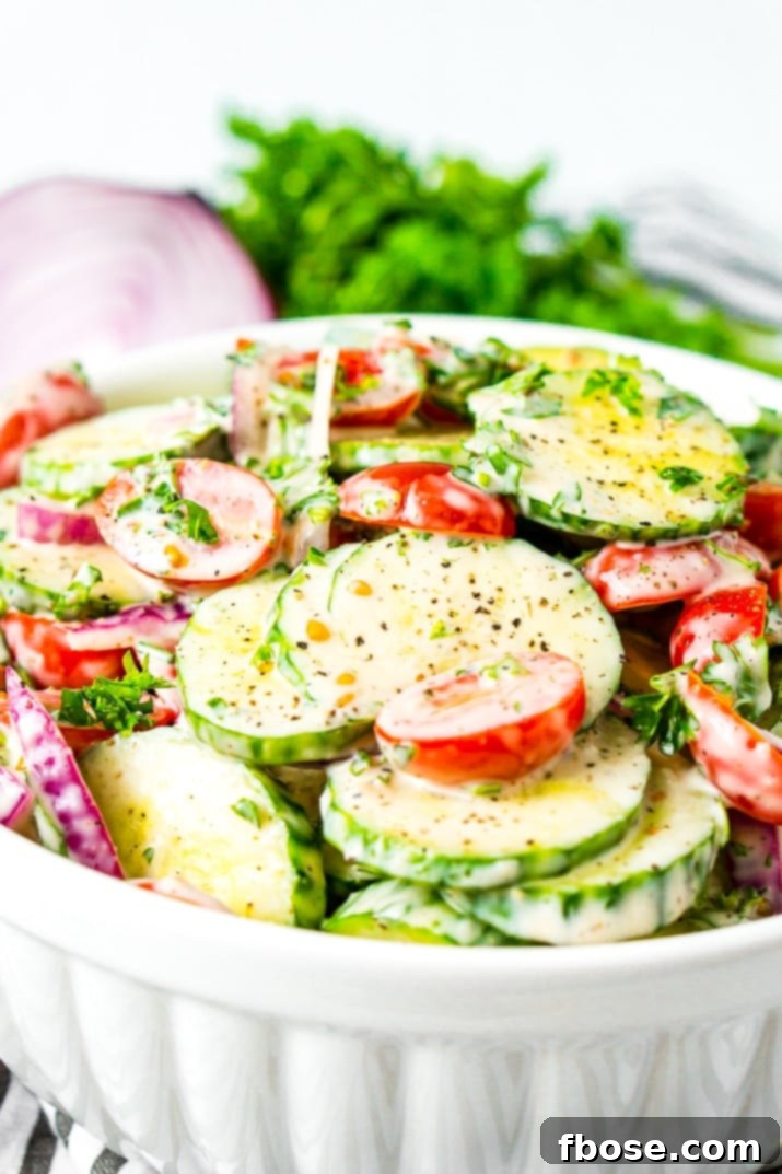 Close-up of a Cucumber Tomato Salad in a clean white bowl, highlighting the fresh and crisp texture of the vegetables, ready for serving.