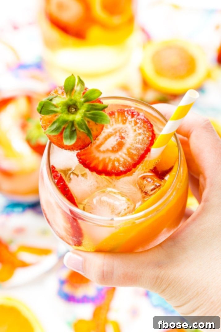 Pitcher of White Wine Sangria with fresh fruit, ready to be served at a summer party or gathering, showcasing its vibrant and refreshing appeal.