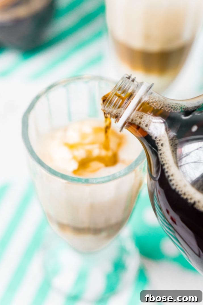 Close-up of a frothy A&W Root Beer Float, showing the contrast between the dark root beer and the white vanilla ice cream, promising a delicious and refreshing experience.