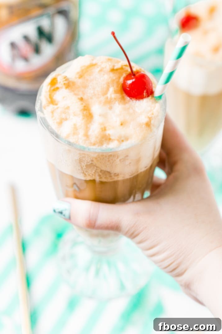A beautifully garnished A&W Root Beer Float, topped with whipped cream and a cherry, ready to be enjoyed. The rich colors highlight its delicious appeal.