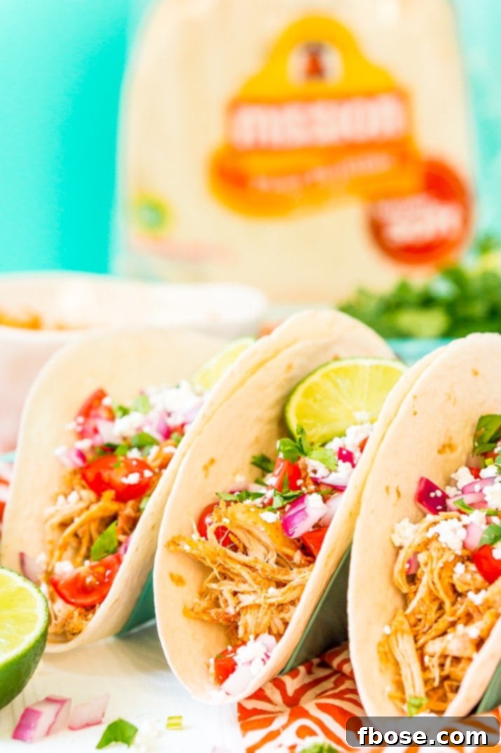 Savory Pulled Chicken Tacos 5 A vibrant spread of taco toppings and shredded chicken for a taco bar