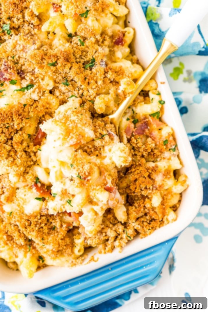 Loaded Bacon Triple Cheese Mac 3 Three Cheese Bacon Mac and Cheese in Pan with serving spoon.