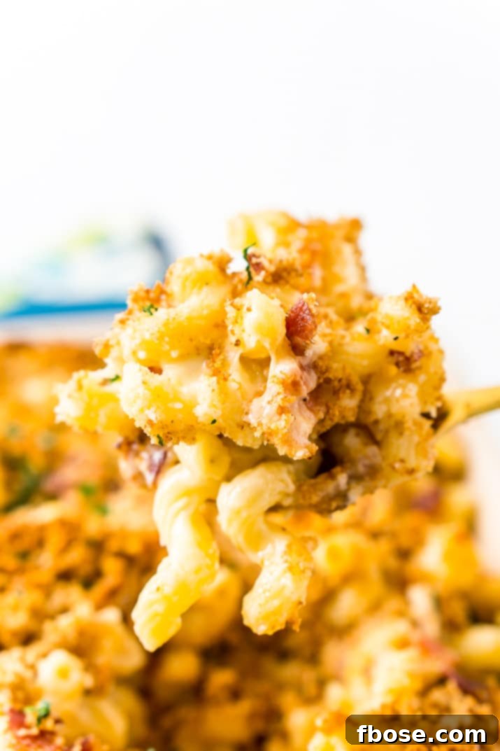 Loaded Bacon Triple Cheese Mac 5 Serving spoon with three cheese bacon mac and cheese