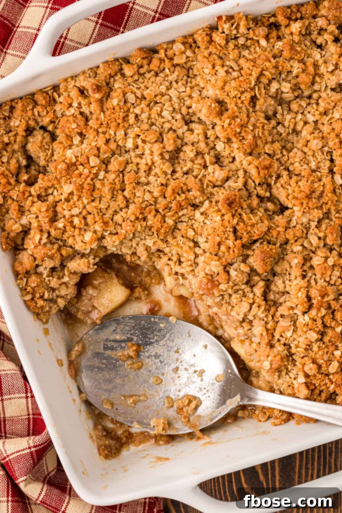 Comforting Apple Oat Crumble 3 Overhead photo of apple crisp with a serving spoon in it.