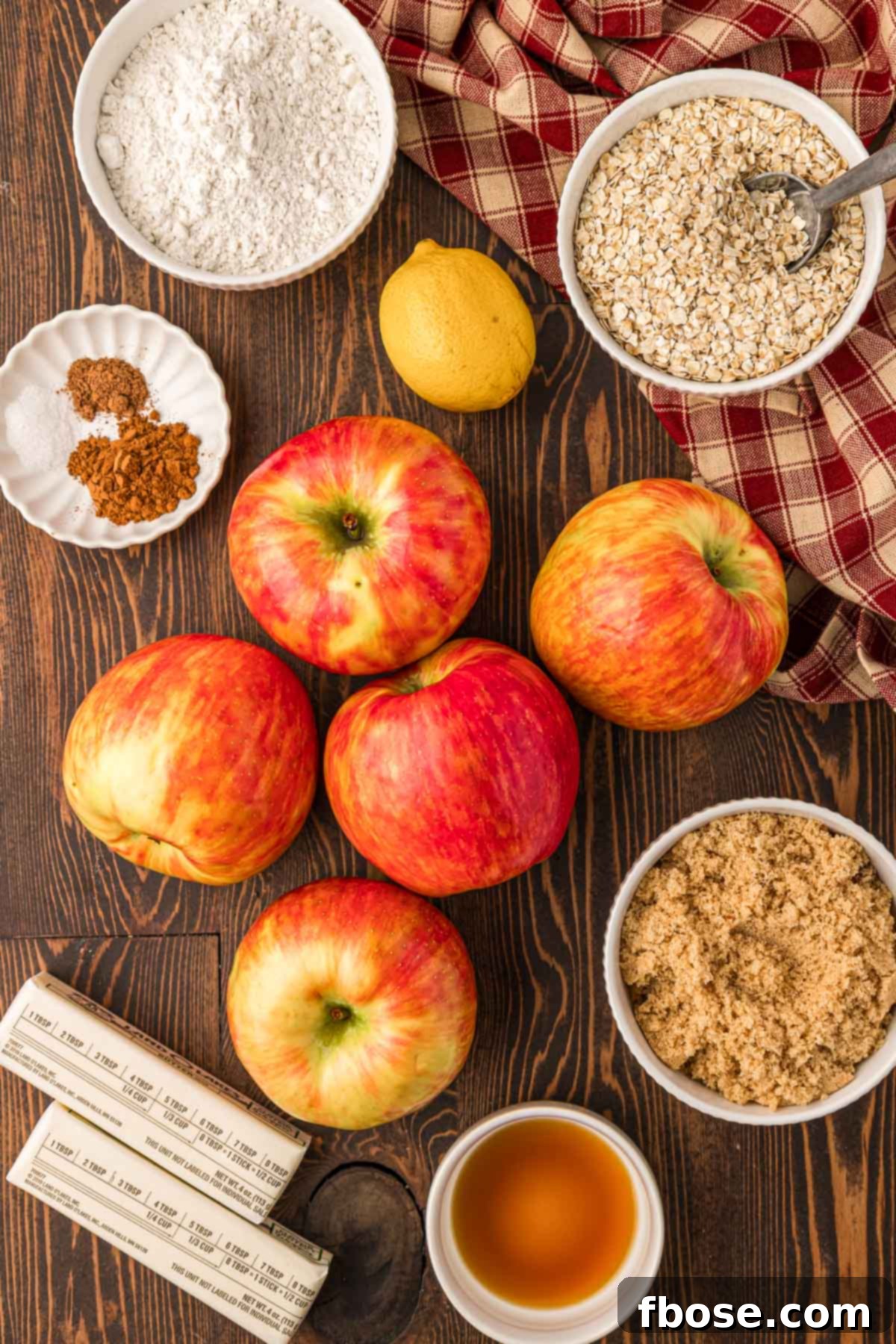 Comforting Apple Oat Crumble 4 Overhead photo of ingredients to make apple crisp on a wooden table.