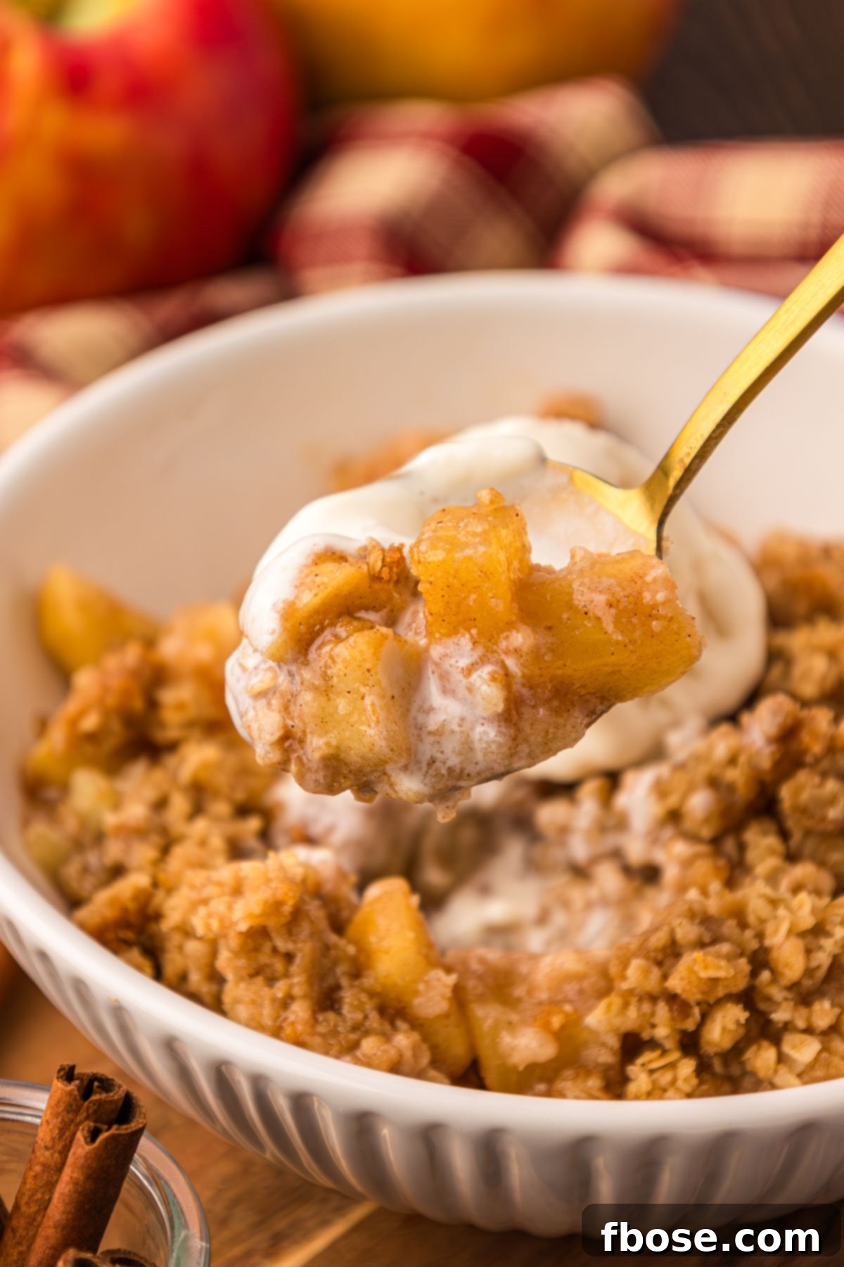Comforting Apple Oat Crumble 9 A spoon lifting a bite of apple crisp to the camera.