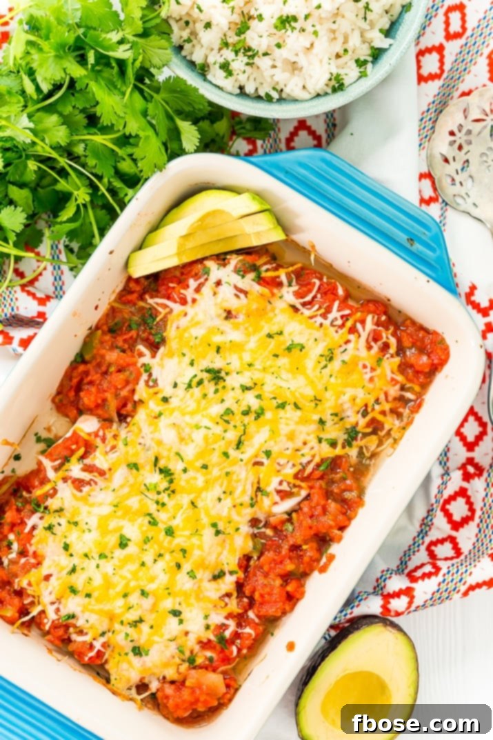 Zesty Salsa Chicken 3 Overhead photo of a steaming Salsa Chicken Bake in a blue baking dish, garnished with fresh cilantro.