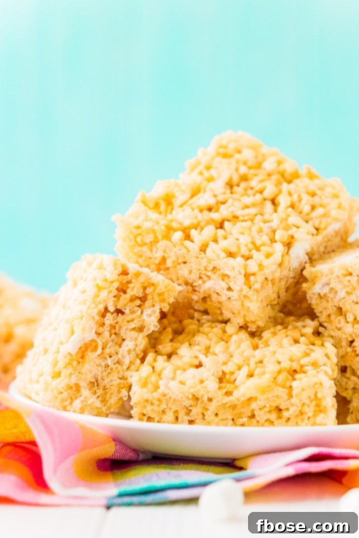 Sweet Crispy Mallow Squares 3 Perfectly balanced Rice Krispies Treats, showcasing the ideal ratio of salty butter, sweet marshmallow, and crispy cereal for an easy, delicious, and quick no-bake dessert.