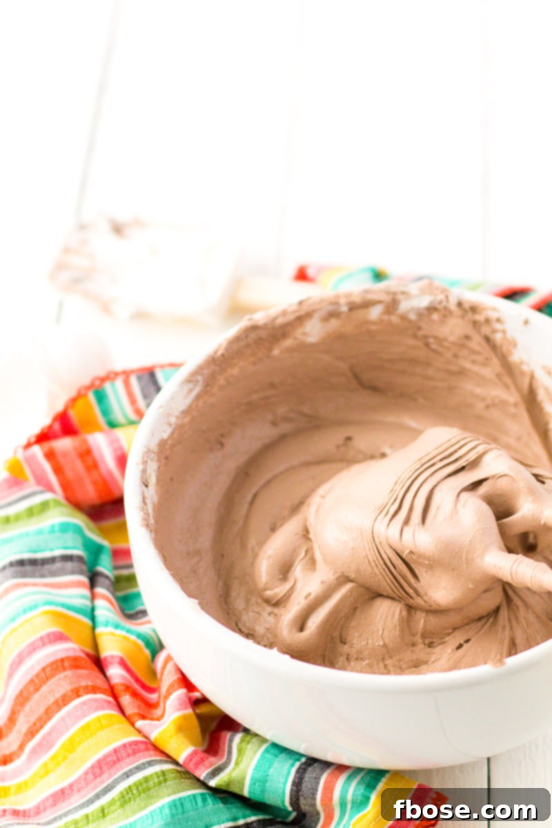 Ingredients for Cool Whip Cookies laid out: Cool Whip, cake mix, eggs, and powdered sugar.