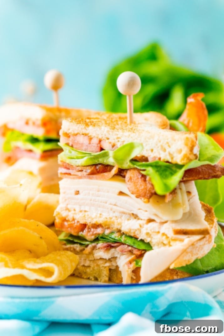 The Ultimate Classic Club Sandwich Recipe: an easy and classic sandwich made with hickory smoked turkey breast, Swiss cheese, thick-cut bacon, lettuce, tomato, and mayonnaise. It’s a great lunch or light dinner recipe!