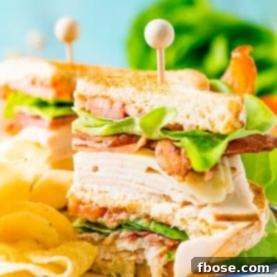 A beautifully assembled, classic Turkey Club Sandwich, ready to be enjoyed.