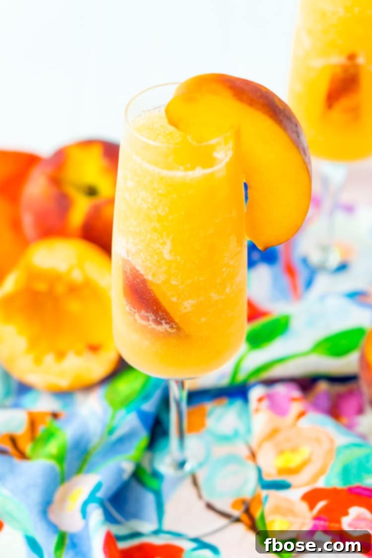 A selection of beautifully presented Peach Bellini Slushies in champagne flutes, artfully arranged on a rustic wooden tray, ready for serving.