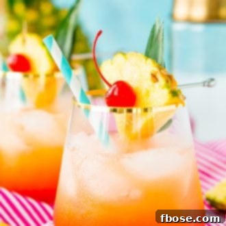 A vibrant Mai Tai cocktail with a pineapple wedge and cherry garnish.
